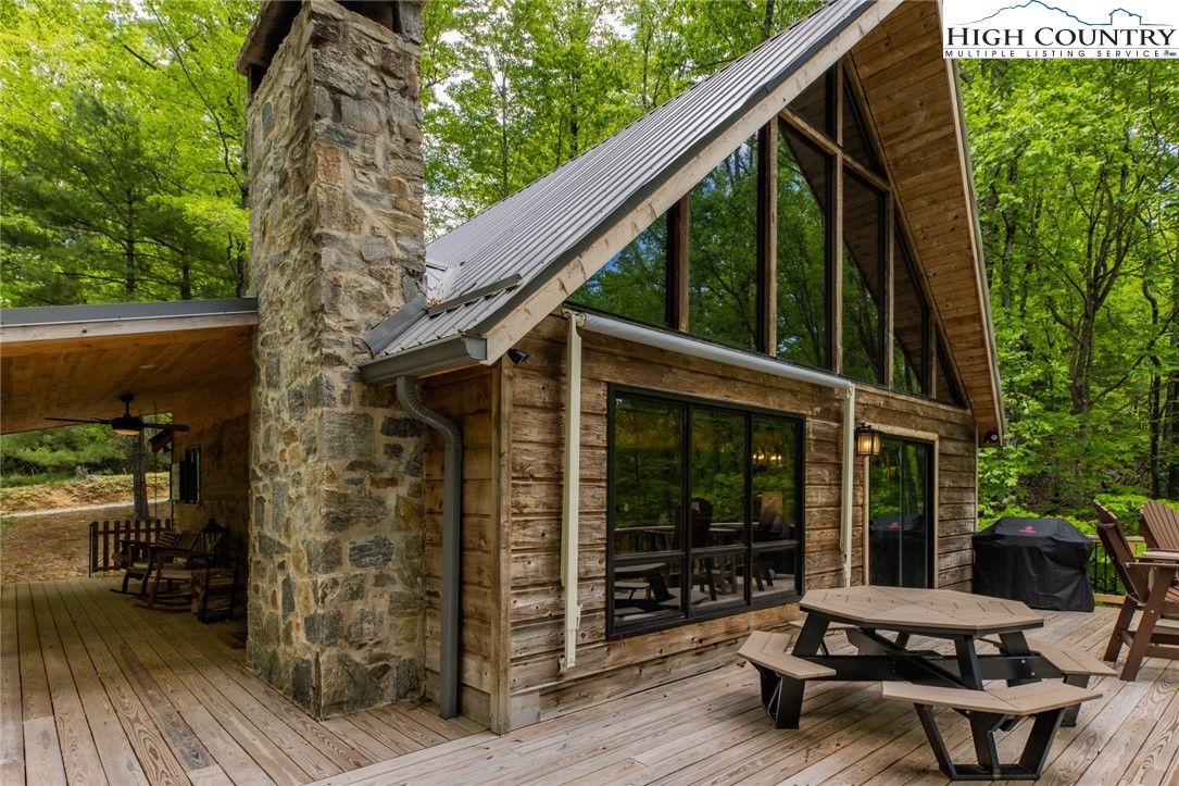 495 Horseshoe Ridge Road East Deep Gap, NC 28618 - Photo 6 of 33 a view of backyard with outdoor seating and trees