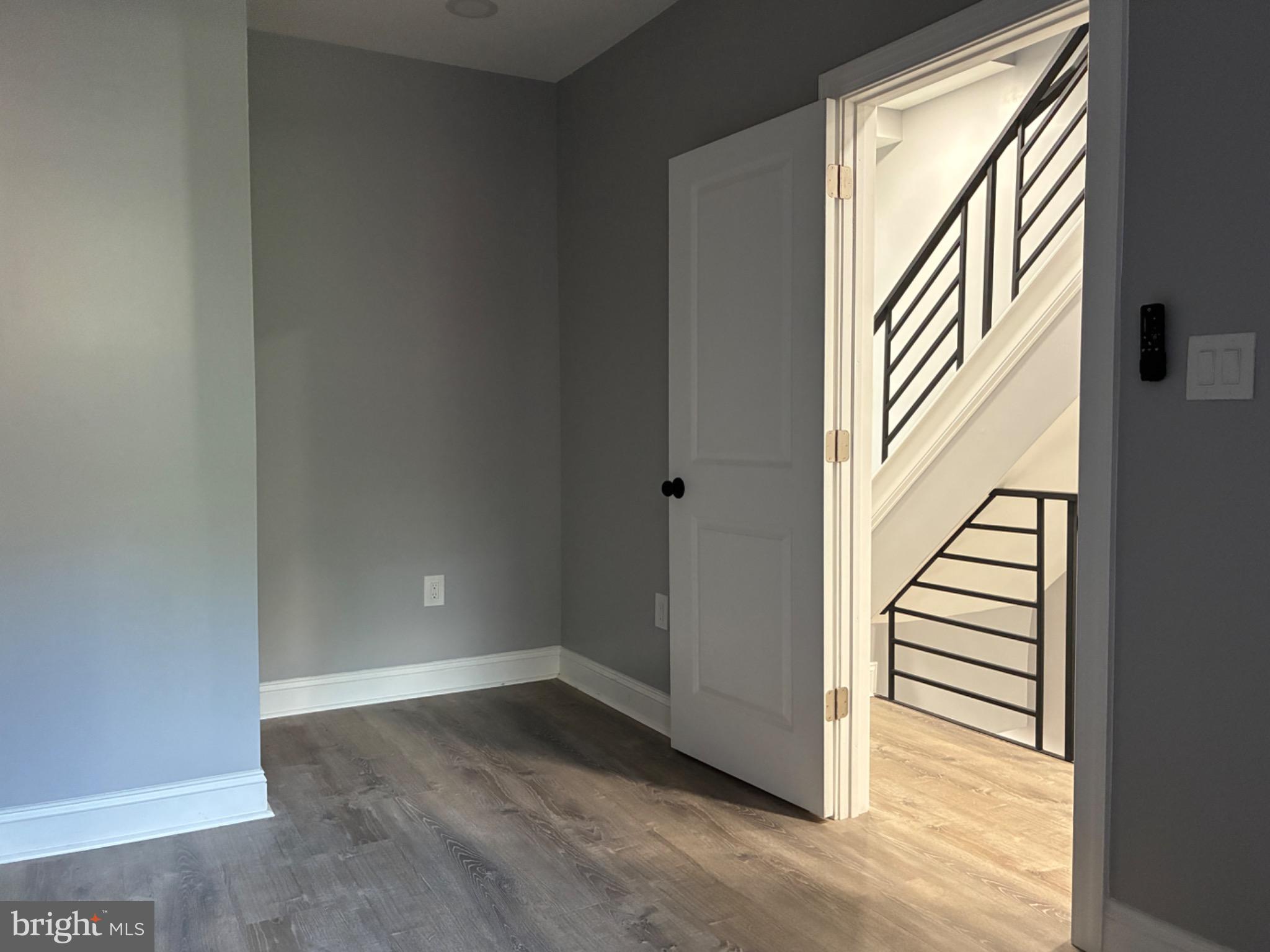 5812 Willows Avenue Philadelphia, PA 19143 - Photo 13 of 27 wooden floor in an empty room with a window