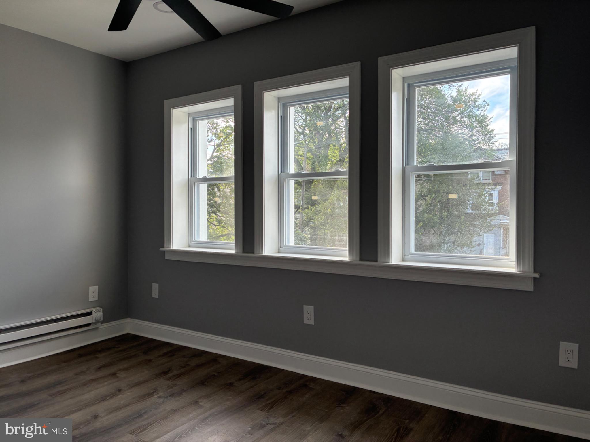 5812 Willows Avenue Philadelphia, PA 19143 - Photo 14 of 27 a view of an empty room with wooden floor and a window