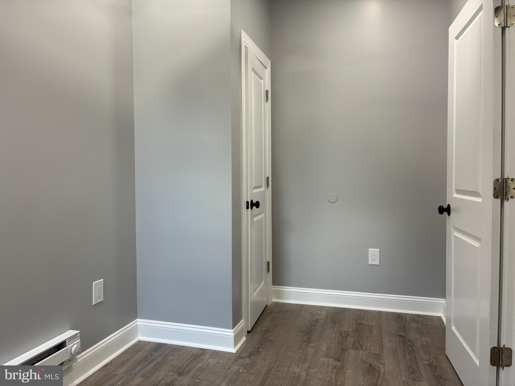 5812 Willows Avenue Philadelphia, PA 19143 - Photo 19 of 27 an empty room with wooden floor and entrance