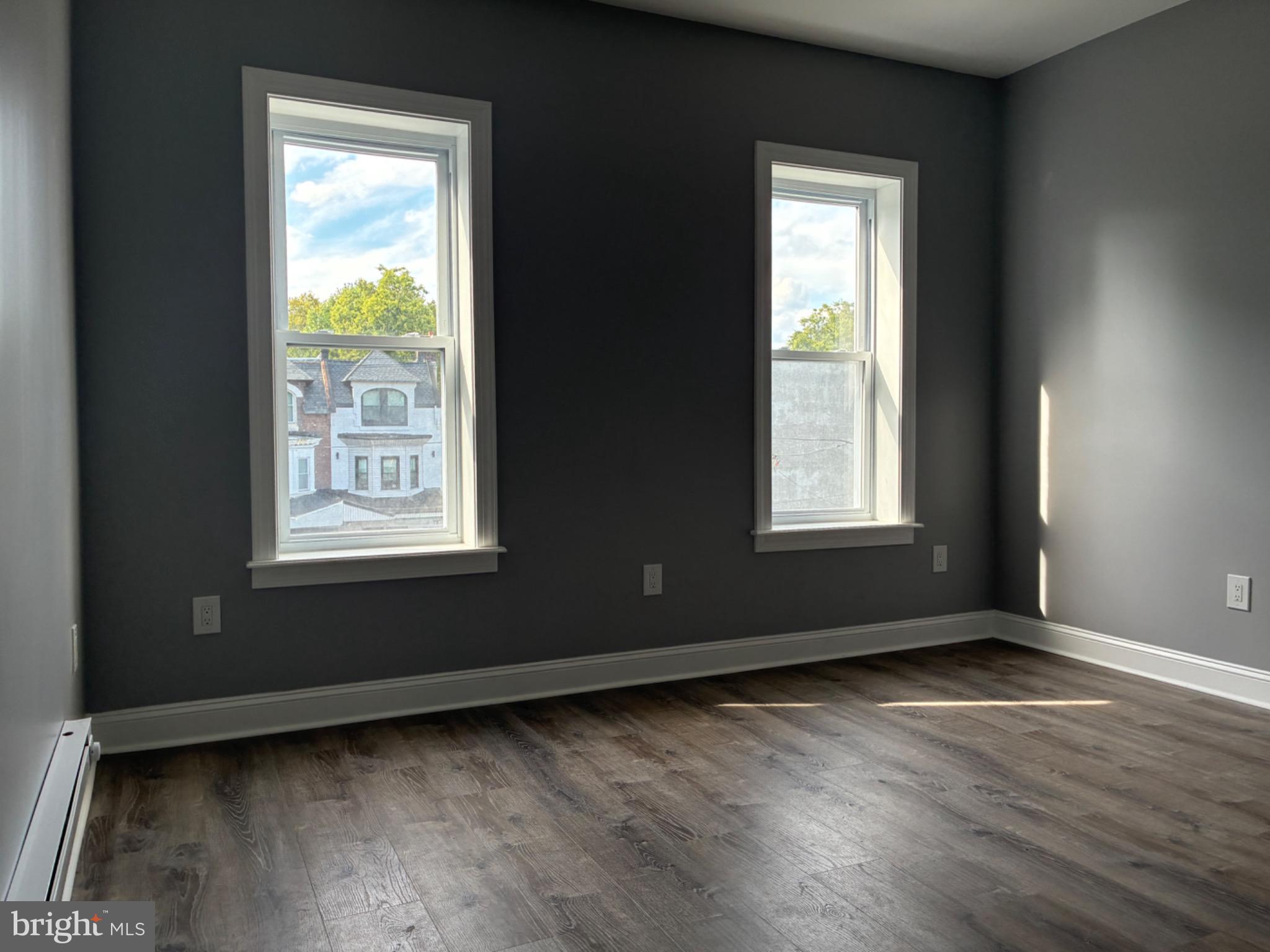 5812 Willows Avenue Philadelphia, PA 19143 - Photo 20 of 27 an empty room with wooden floor and windows