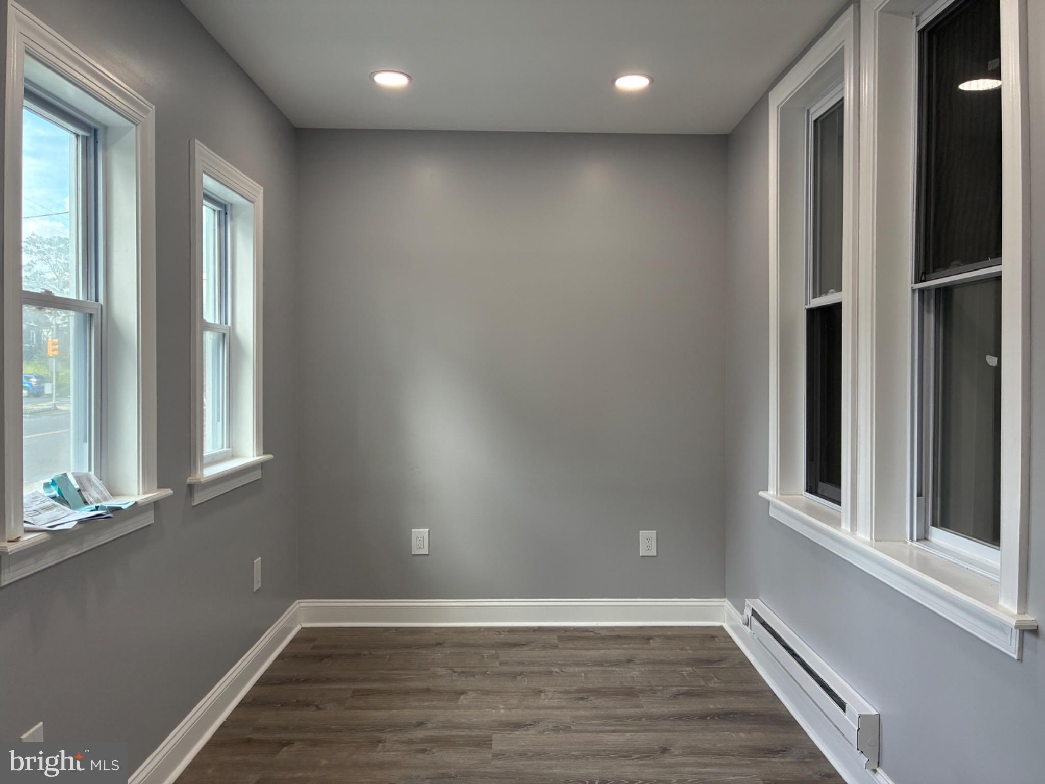 5812 Willows Avenue Philadelphia, PA 19143 - Photo 2 of 27 a view of an empty room with wooden floor and a window