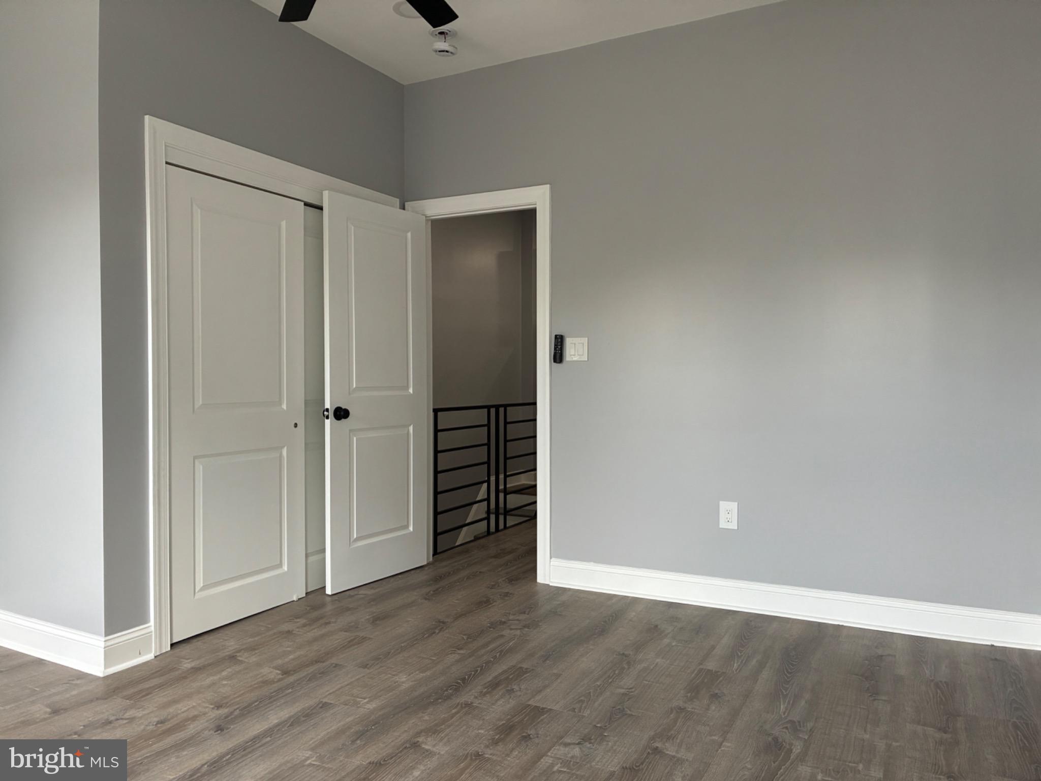 5812 Willows Avenue Philadelphia, PA 19143 - Photo 22 of 27 a view of an empty room with wooden floor and a ceiling fan