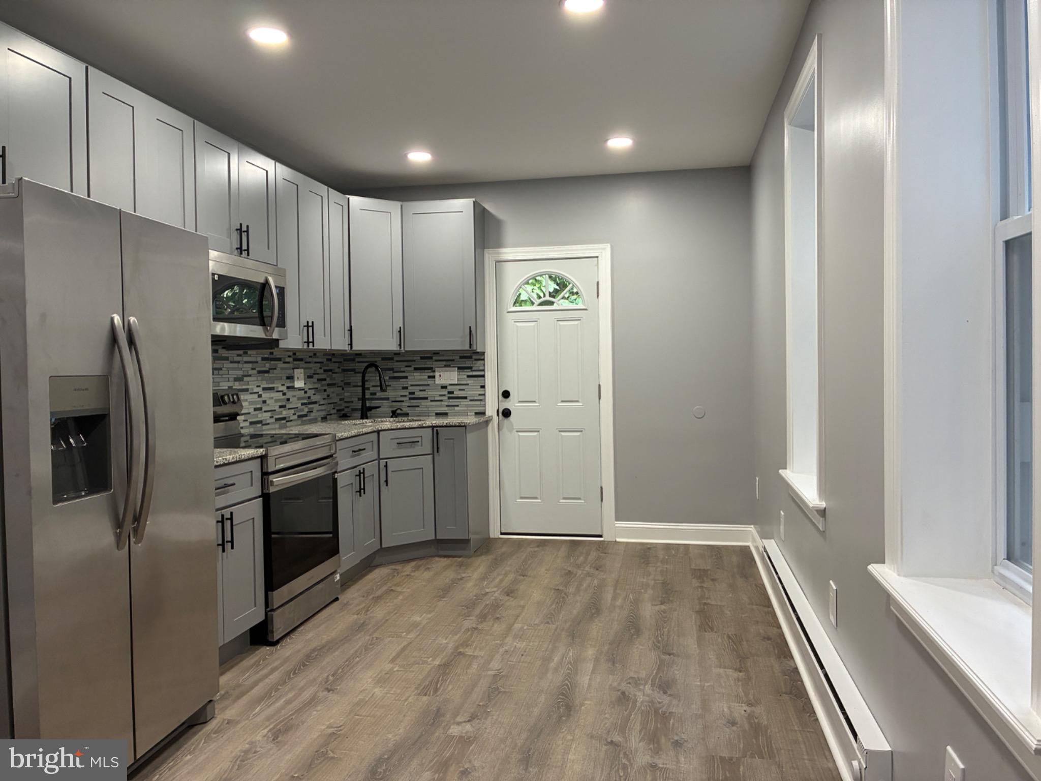5812 Willows Avenue Philadelphia, PA 19143 - Photo 5 of 27 a kitchen with a refrigerator stove and microwave