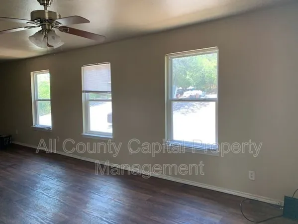 a view of kitchen with stainless steel appliances granite countertop a refrigerator and a stove