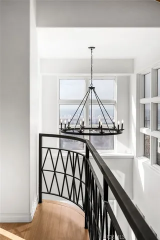 a bedroom with a bed a large window and walk in closet