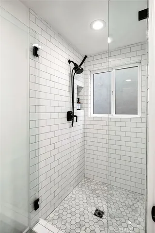 a bathroom with a double vanity sink a mirror and a bathtub