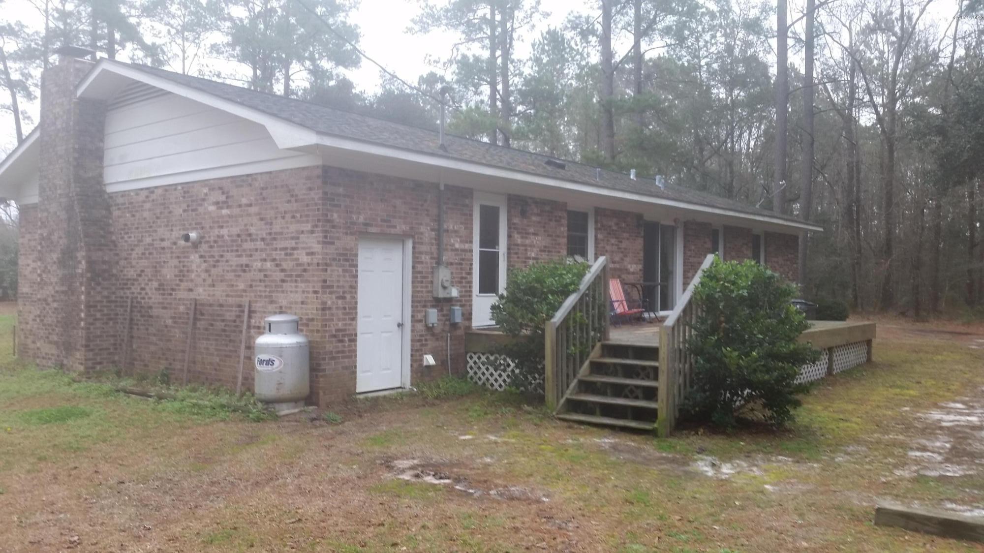 6443 Funston Road Southeast Winnabow, NC 28479 - Photo 20 of 25 Side of house with door to storage and stairs to deck