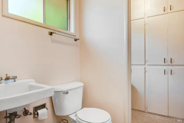 a white toilet sitting next to a bathroom sink