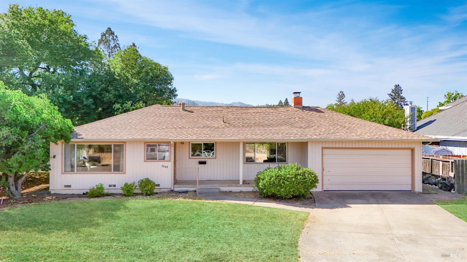 2040 Olive Avenue St. Helena, CA 94574 - Photo 2 of 25 a front view of a house with a yard and potted plants