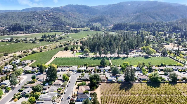 an aerial view of a city with mountains lake view