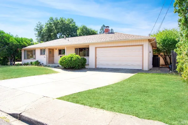 a front view of house with yard and green space