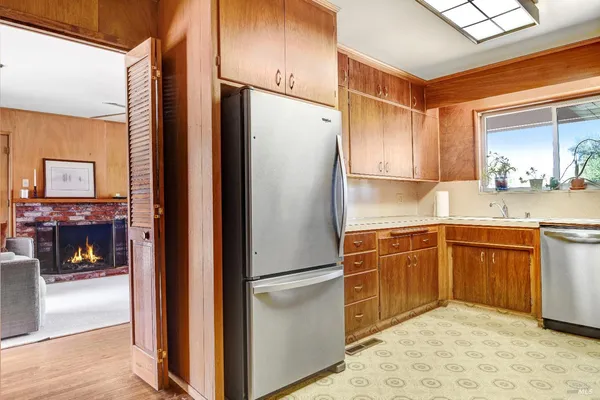 a kitchen with stainless steel appliances granite countertop a refrigerator and a sink