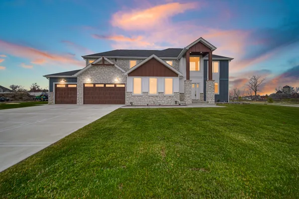 a front view of a house with a yard and porch