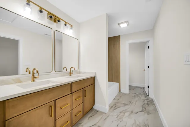 an empty room with a ceiling fan and wooden floor