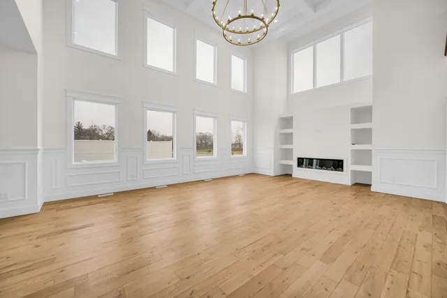 a large kitchen with kitchen island a sink a center island a stove and a window