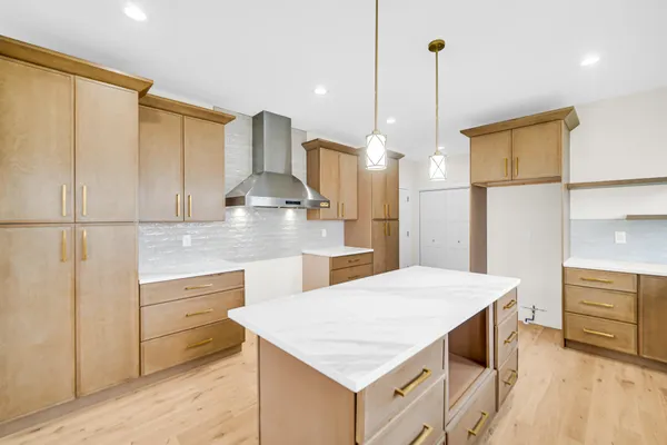 a kitchen with kitchen island white cabinets and stainless steel appliances