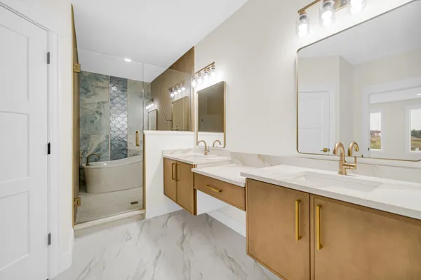 a bathroom with a granite countertop sink mirror and bathtub