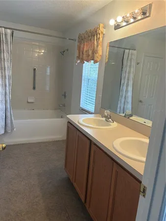 a empty walk in closet with wooden floor