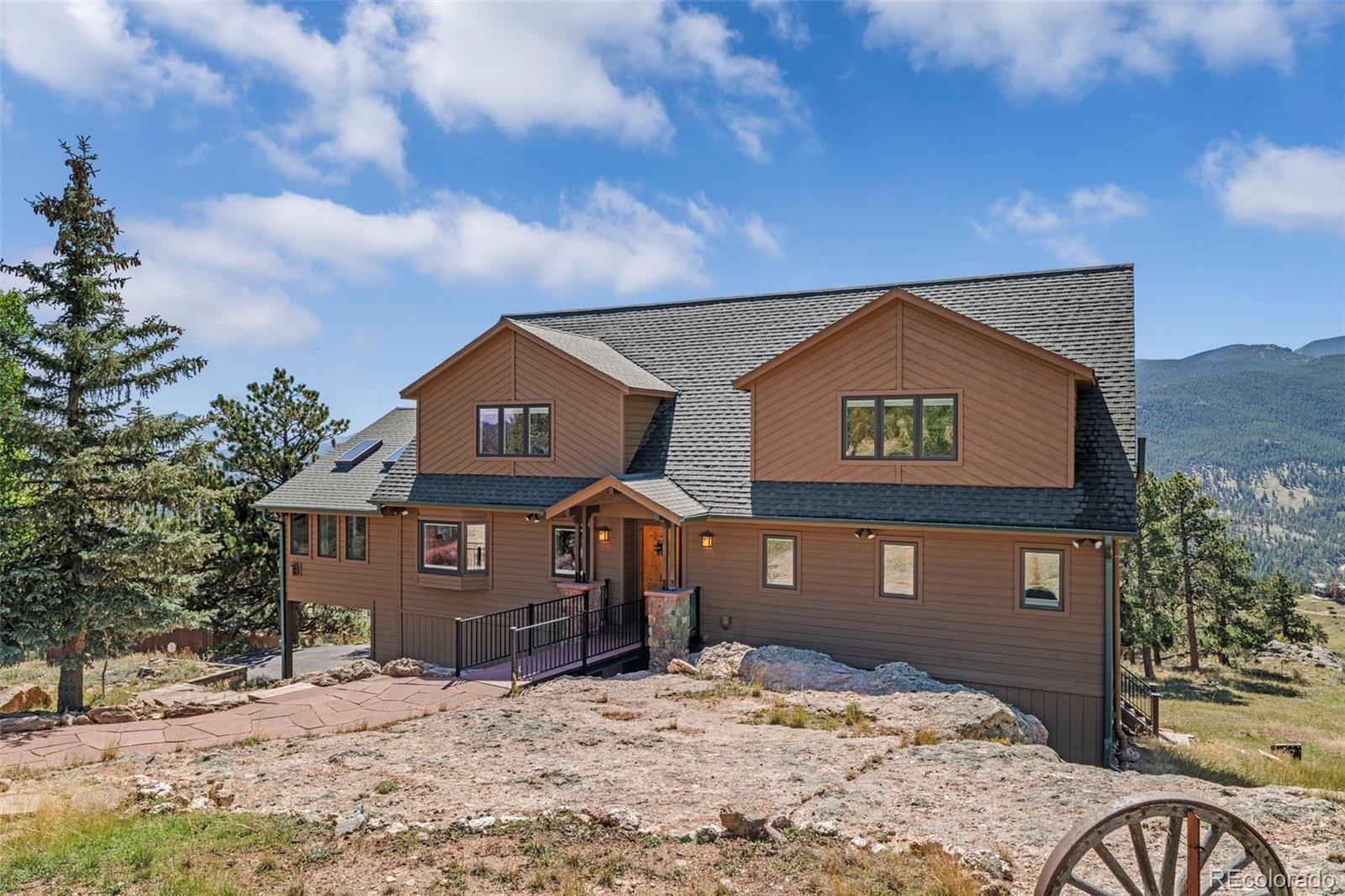 830 Jesse Lane Bailey, CO 80421 - Photo 3 of 45 a front view of a house with a yard