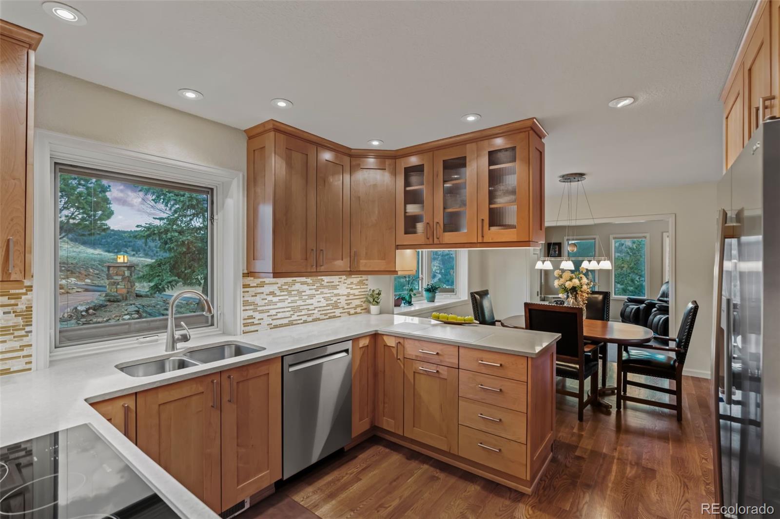 830 Jesse Lane Bailey, CO 80421 - Photo 8 of 45 a kitchen with a sink appliances cabinets and dining table