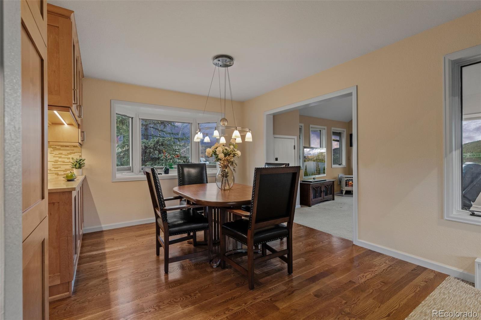 830 Jesse Lane Bailey, CO 80421 - Photo 9 of 45 a view of a dining room with furniture window and wooden floor