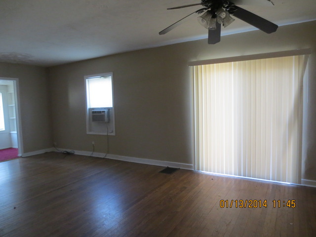 114 West Roosevelt Road Wheaton, IL 60187 - Photo 2 of 16 an empty room with wooden floor chandelier fan and windows