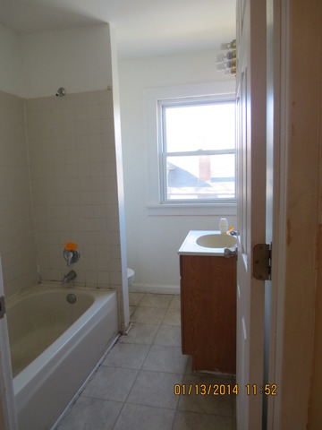 114 West Roosevelt Road Wheaton, IL 60187 - Photo 11 of 16 a bathroom with a bathtub and a shower