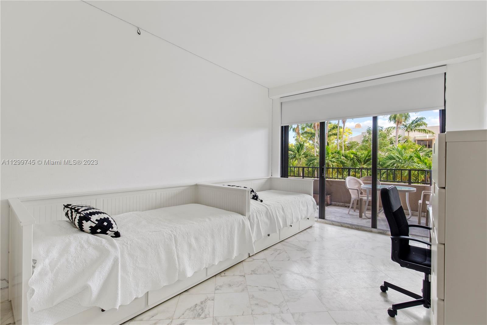 151 Crandon Boulevard, Unit 340 Key Biscayne, FL 33149 - Photo 12 of 26 a living room with furniture and a large window