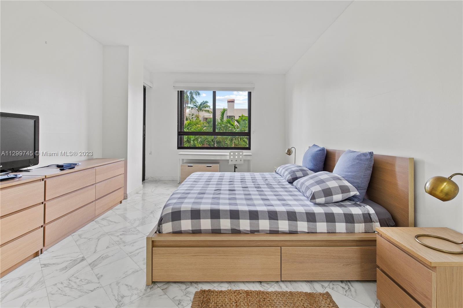 151 Crandon Boulevard, Unit 340 Key Biscayne, FL 33149 - Photo 15 of 26 a bedroom with a bed and a window