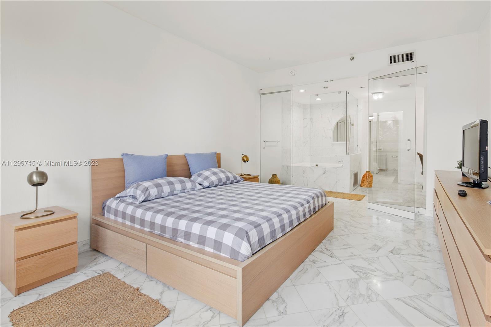 151 Crandon Boulevard, Unit 340 Key Biscayne, FL 33149 - Photo 16 of 26 a bedroom with a bed and a flat screen tv