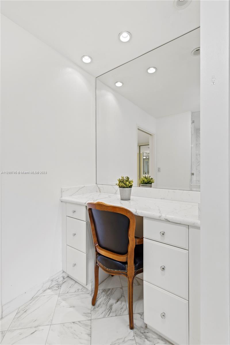 151 Crandon Boulevard, Unit 340 Key Biscayne, FL 33149 - Photo 17 of 26 a bathroom with a sink a chair and a mirror