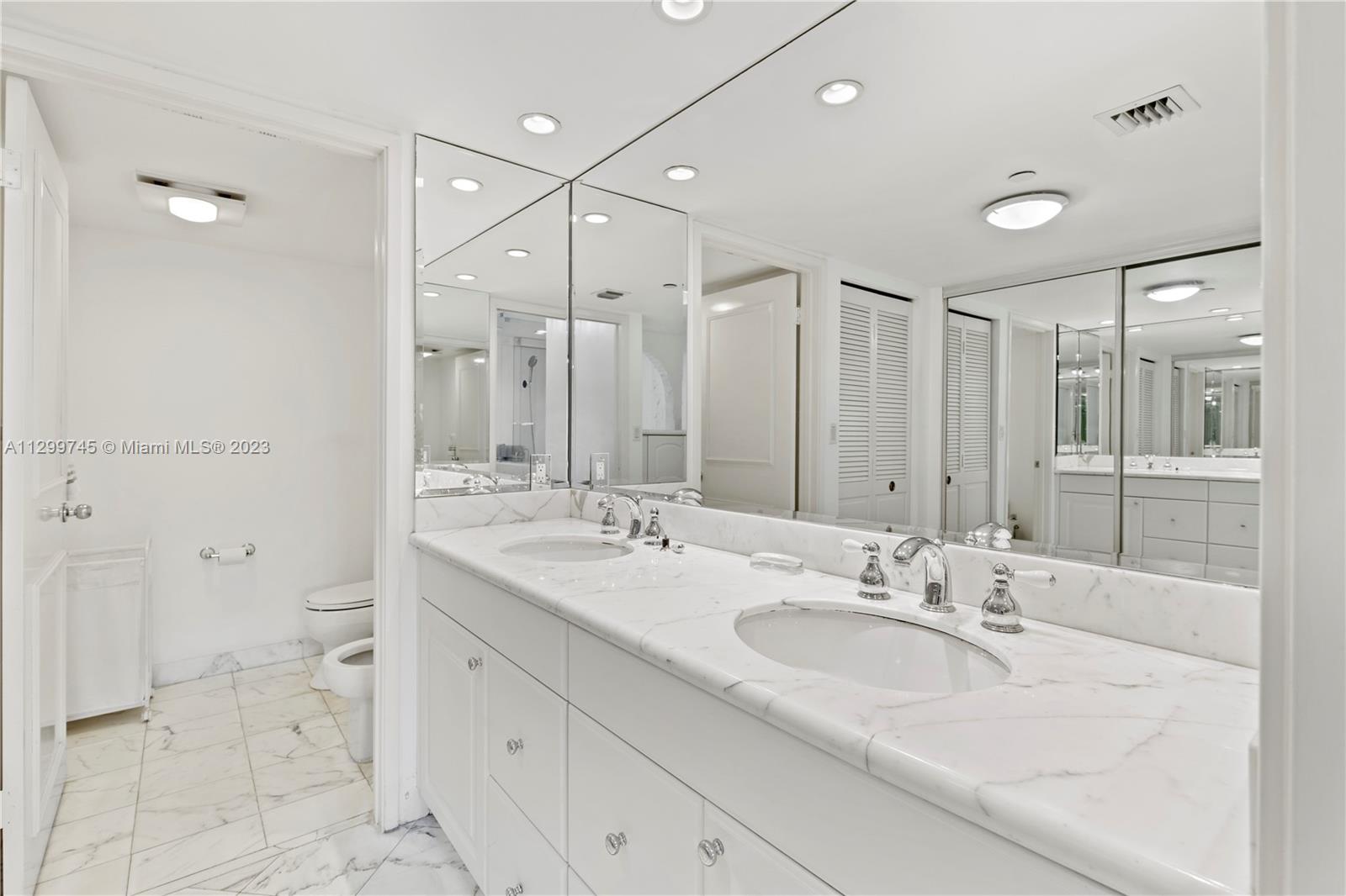 151 Crandon Boulevard, Unit 340 Key Biscayne, FL 33149 - Photo 18 of 26 a bathroom with a double vanity sink mirror and shower