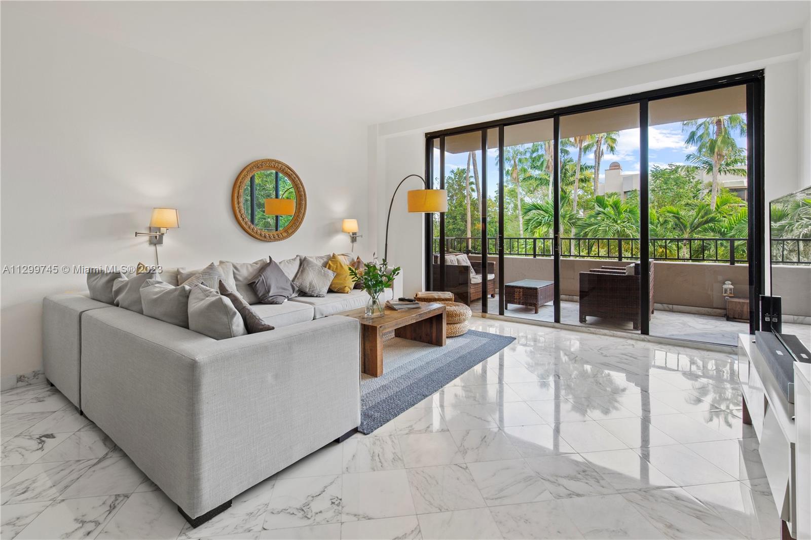 151 Crandon Boulevard, Unit 340 Key Biscayne, FL 33149 - Photo 2 of 26 a living room with furniture and a large window