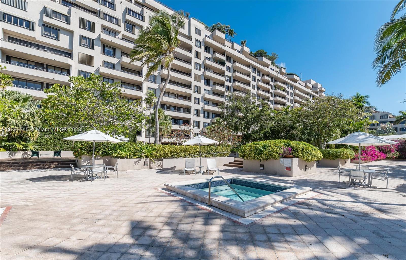 151 Crandon Boulevard, Unit 340 Key Biscayne, FL 33149 - Photo 22 of 26 a lawn chairs sitting in front of a building