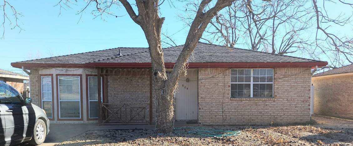 a view of a house with a tree