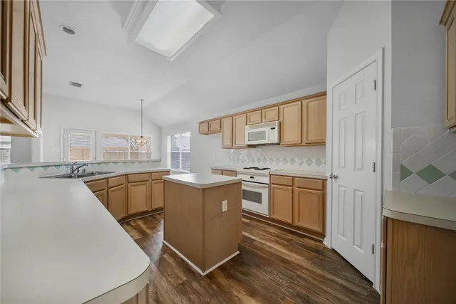 a kitchen with a sink stove and cabinets