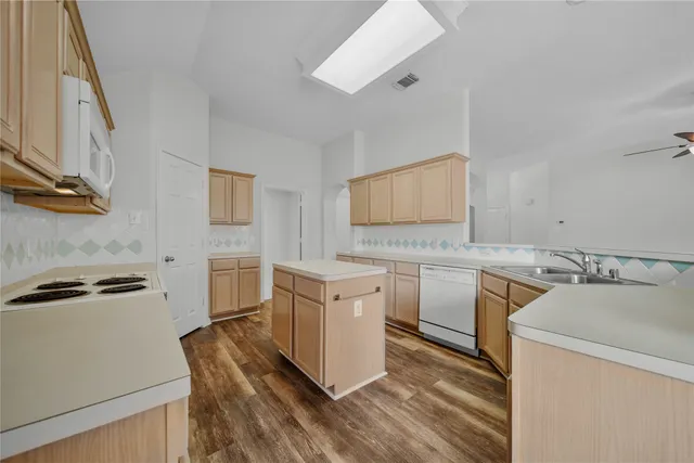 a kitchen with a stove oven and sink