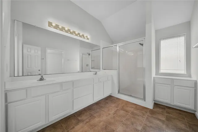 a bathroom with a double vanity sink and a mirror