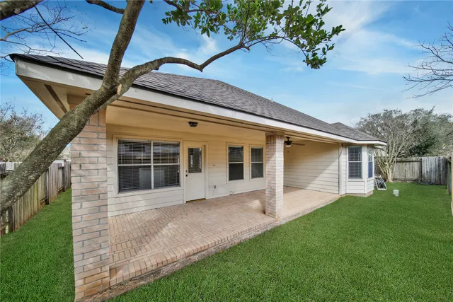 a front view of a house with a garden and yard