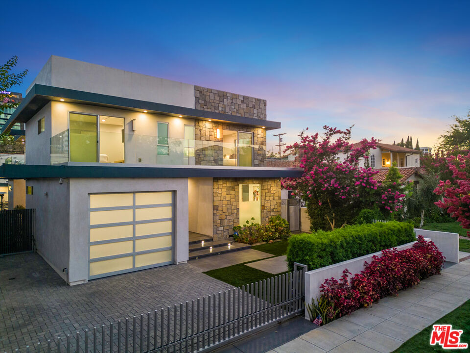a view of a porch with furniture and garden