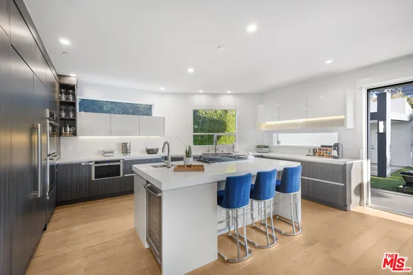 a kitchen with a sink stainless steel appliances and cabinets