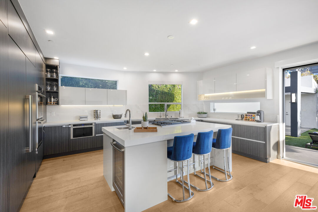 6410 Lindenhurst Avenue Los Angeles, CA 90048 - Photo 12 of 39 a kitchen with a sink stainless steel appliances and cabinets