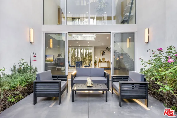 a outdoor sitting area with couch and wooden floor