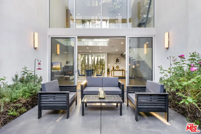 a outdoor sitting area with couch and wooden floor