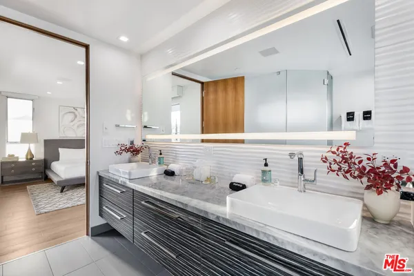 a bathroom with a sink mirror and vanity