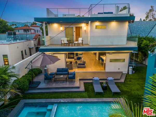 an outdoor view of swimming pool with seating