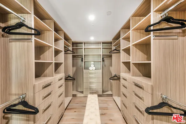 a view of walk in closet with empty racks