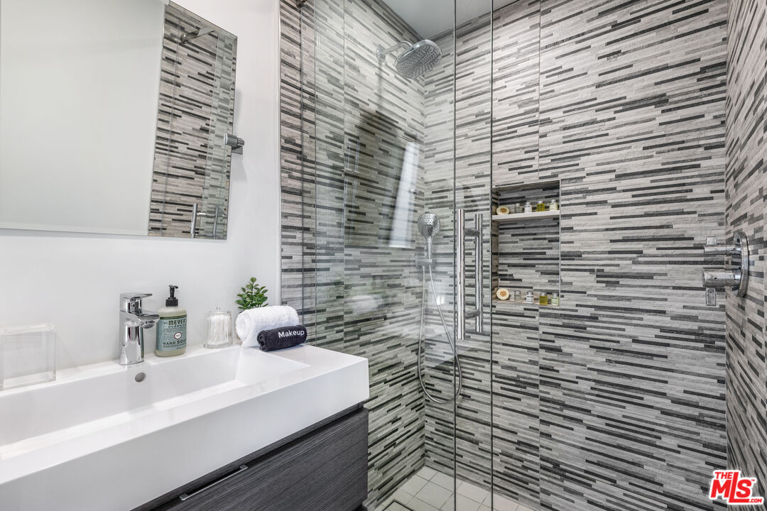 6410 Lindenhurst Avenue Los Angeles, CA 90048 - Photo 24 of 39 a bathroom with a sink a vanity and a shower