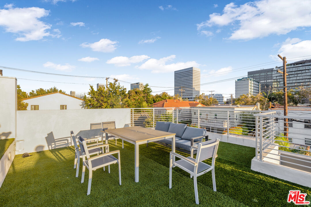6410 Lindenhurst Avenue Los Angeles, CA 90048 - Photo 30 of 39 a view of a chairs and table in patio with a yard